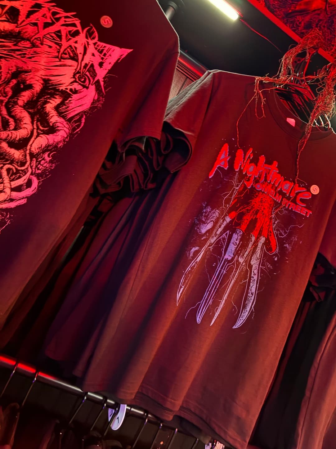 Apparel and prints on the racks inside Tomb Gallery in Salem