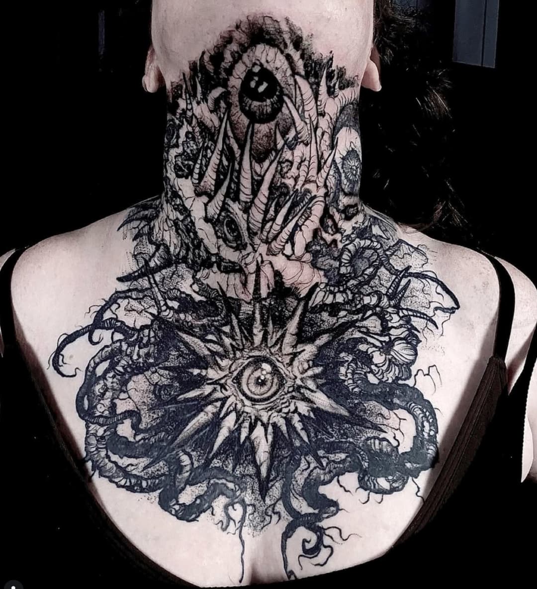 Blackwork tattoo of an eye and tendrils covering a throat and upper chest
